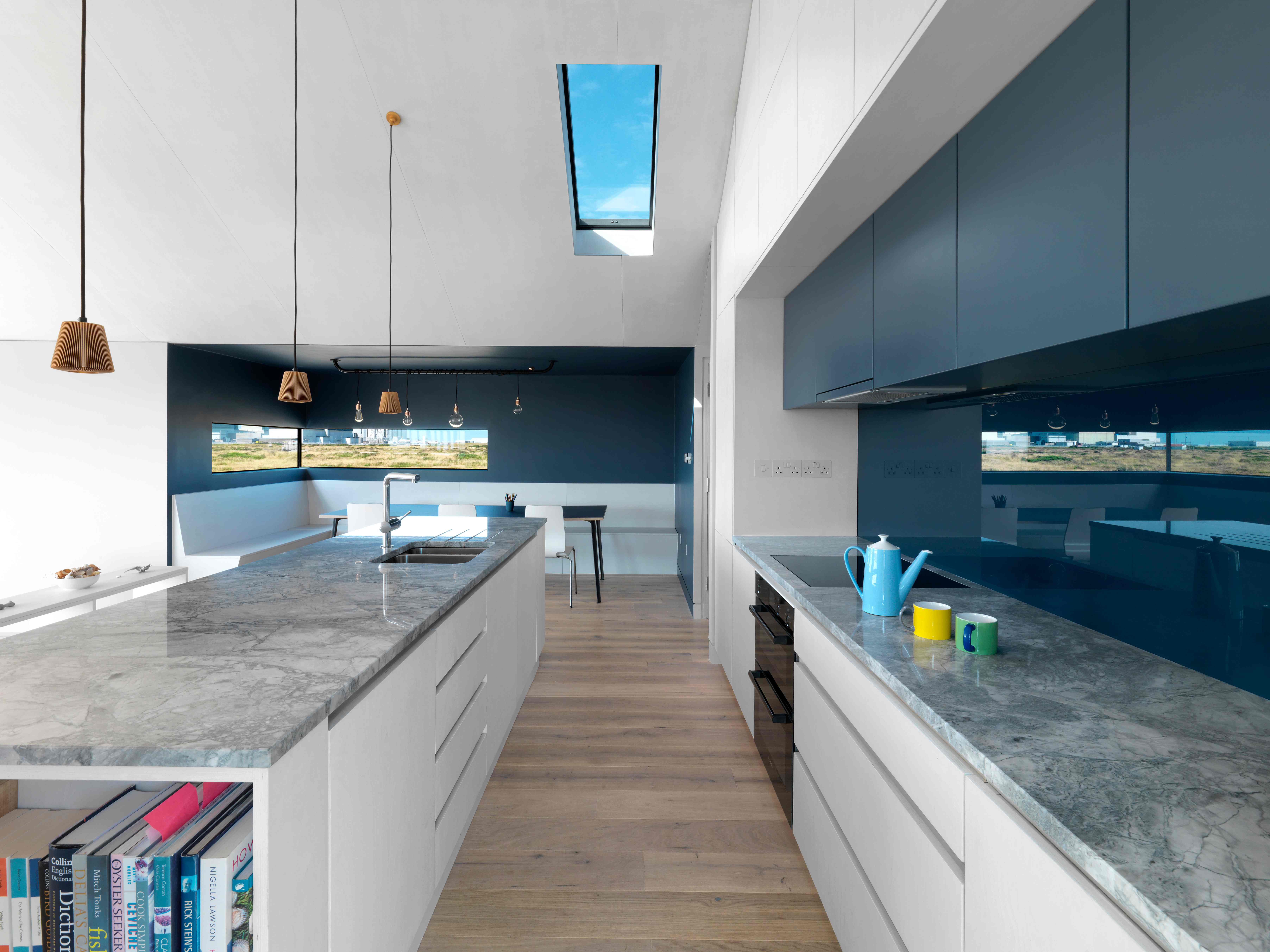 Galley kitchen with blue splashback
