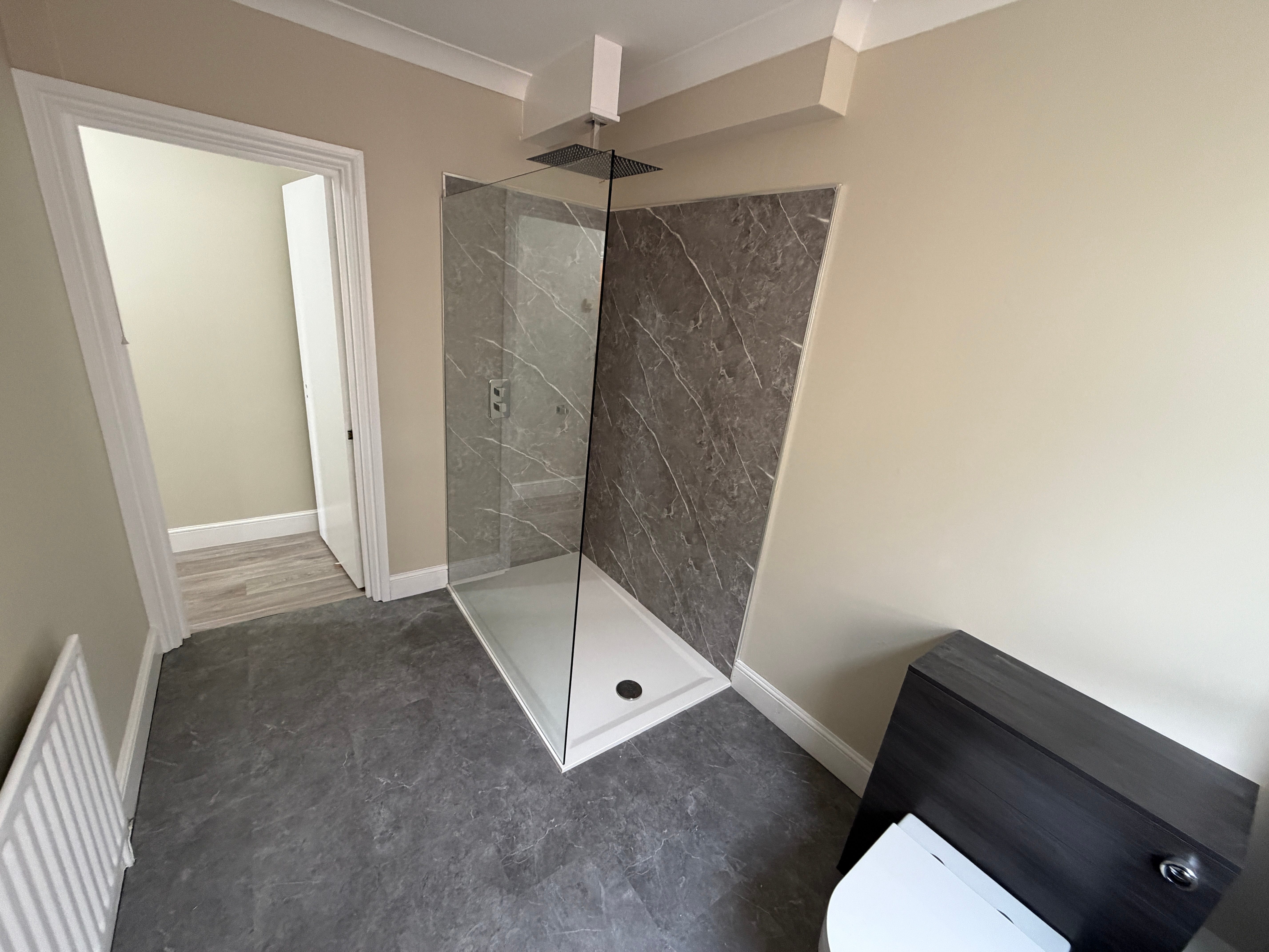 Walk-in shower with marble wall panels