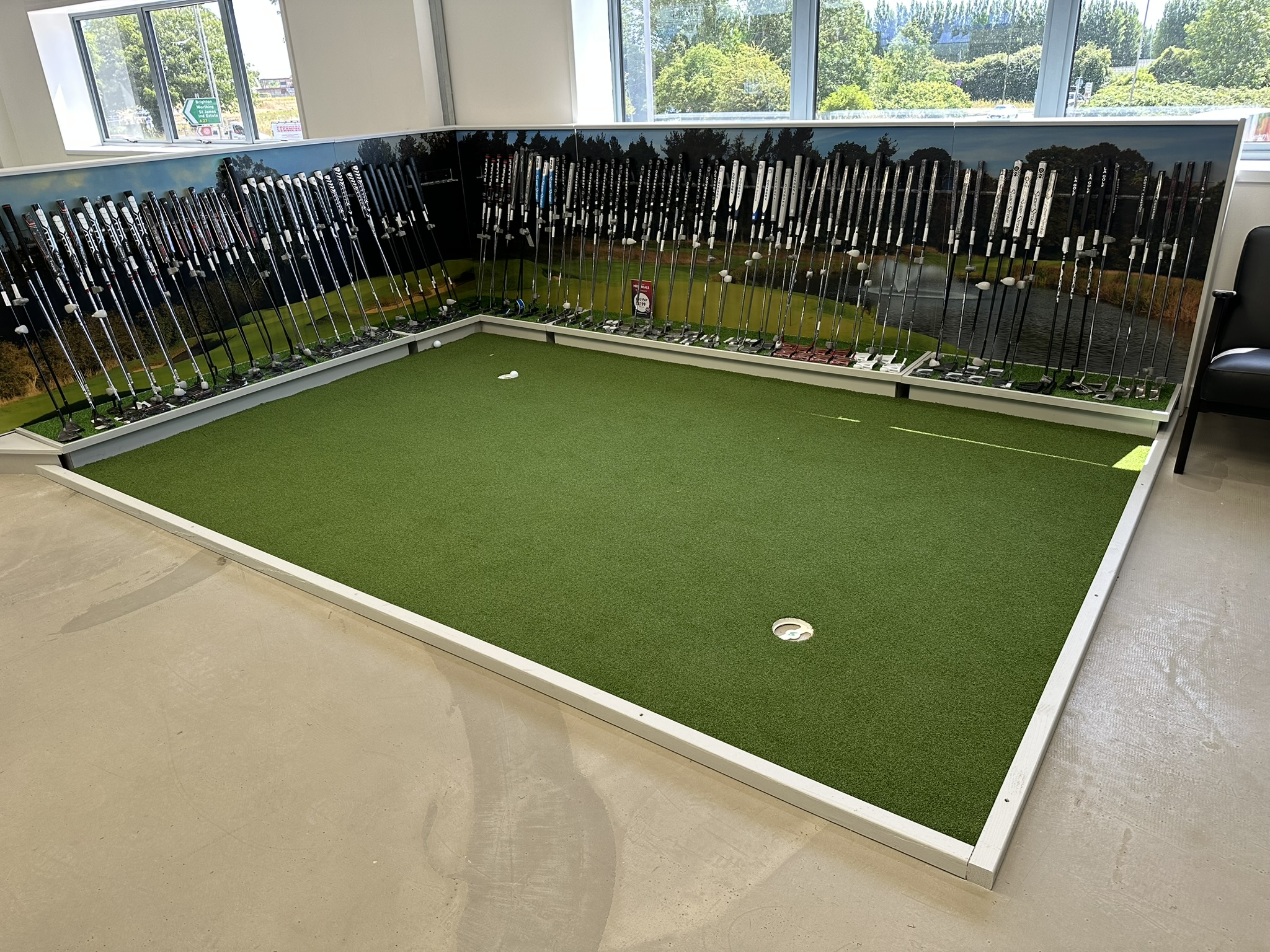 Indoor putting green with putter display