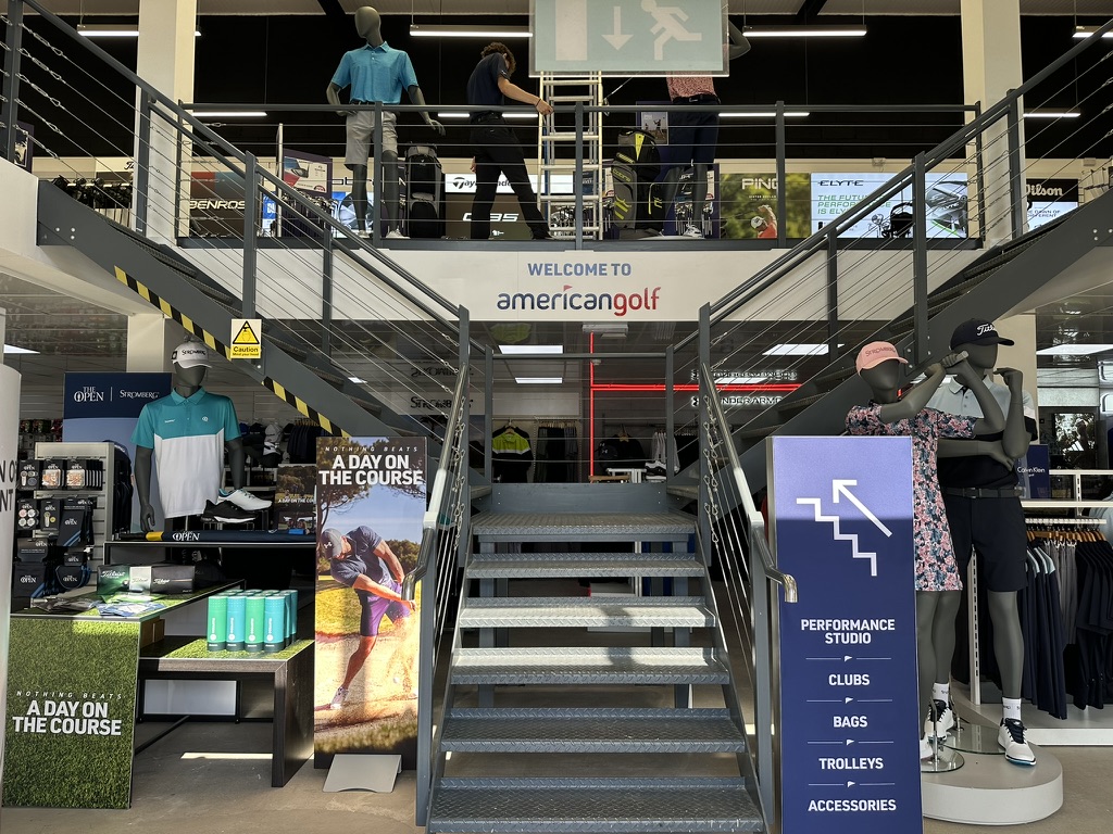 Two-storey store entrance with mezzanine and wayfinding signage